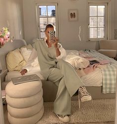 a woman taking a selfie in her bedroom