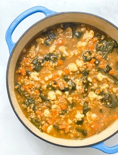 a blue pot filled with soup on top of a white counter