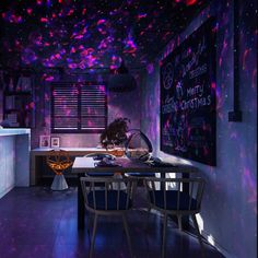 a dining room filled with lots of purple lights