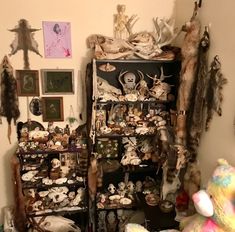 a room filled with lots of stuffed animals and other things on the wall next to it