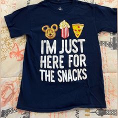 Disney World Kid Snack Shirt. Never Worn. Size S. Kid Bin 2 Blue Themed Shirt With Character Print, Blue Short Sleeve Themed Shirt, Disney Snack Shirt, Disney Shirts For Teens Boys, Here For The Snacks Disney Shirt, Boy Disney Shirt, Disney Graphic Print Blue Shirt, Fun Mickey Mouse Shirt For Disney Trips, Fun Blue Mickey Mouse T-shirt