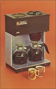 an advertisement for coffee maker with two cups