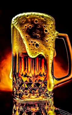 a large glass mug filled with liquid on top of a wooden table next to a black background