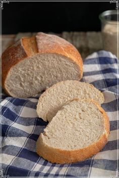 two loaves of bread sitting on top of a blue and white checkered cloth