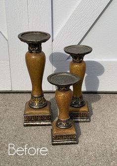 two vases sitting next to each other on top of a cement floor in front of a white door