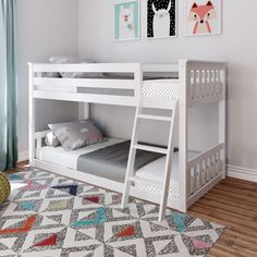 a white bunk bed sitting on top of a hard wood floor next to a window