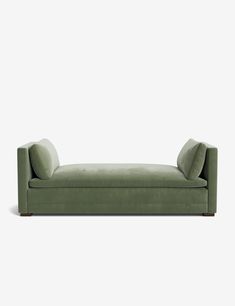 a green couch sitting on top of a white floor