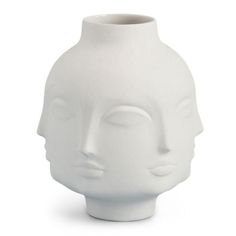 a white vase that has a face on the front and side of it, with eyes closed