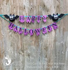 a halloween banner hanging on the side of a wooden wall with two bats and one bat