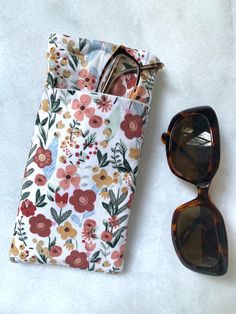 Details: My DOUBLE eyeglass case are made from quality cotton fabric with a pre quilted fabric on the inside.  It will hold both your regular glasses and sunglasses.  see pics. The dimensions are 7.5"x3.75" with a 6" front pocket.   ** Exterior- Boho floral ** Interior- Pre quilted fabric  ** Top stitched Care:  Wash in warm water and air dry.  Smooth out wrinkles with an iron if needed.    Pattern placement/color will vary slightly Shipping: Items will be ship via USPS within 5-7 business days.  Refunds/Returns: * See shop for more details Other: * I am trying to reduce waste, so if you need a paper receipt, please let me know. All my items are sewn in a pet and smoke free home in North Carolina. Thank you for supporting my small business and made in the USA. Please contact me if you have Sunglasses Case Sewing Pattern, Pouch Aesthetic, Pre Quilted Fabric, Glasses Pouch, Glasses Cases, Floral Interior, Handmade Sewing, Quilted Fabric, Eye Wear Glasses