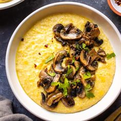 two bowls filled with soup and topped with mushrooms