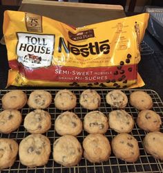 chocolate chip cookies cooling on a rack next to a bag of nestle's semi - sweet morsels