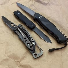 three different types of knifes are laying on the table next to each other,