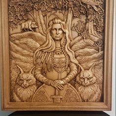 a wooden plaque with an image of a woman surrounded by animals