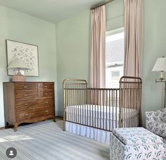 a baby's room with a crib and dresser