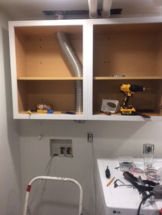 a room that has some shelves and tools in it