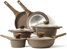 a set of pots and pans with wooden handles