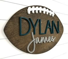 a wooden sign that says, dyan james with a football on the front and side