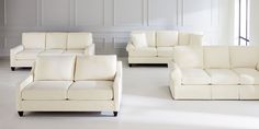 three white couches and one chair are in a room with white tile flooring