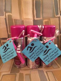 several pink candles with tags on them sitting next to each other