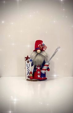 a patriotic gnome figurine holding a baseball bat