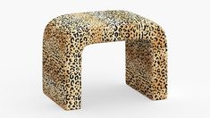 an animal print stool with a curved design on the top and bottom, sitting in front of a white background