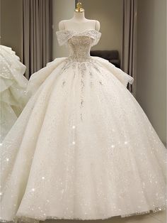 Sail into your wedding day with confidence and grace in this stunning ball gown, designed for the bride who wants to shine. The gown features an off-the-shoulder neckline embellished with delicate beading that flows seamlessly into a fitted bodice. The bodice is intricately decorated with sparkling details, ensuring all eyes are on you. The skirt is a masterpiece, with layers of shimmering fabric that create a voluminous and fairy-tale-like silhouette. The luxurious material drapes beautifully, allowing for ease of movement and comfort. This dress is perfect for grand and lavish weddings, making you feel like a true princess. With its exquisite design and sparkling details, this dress will make your wedding day unforgettable. You can choose a standard size or leave us custom size, for cust Tulle Ruffle Wedding Dress, Ruffles Wedding Dress, Shoulder Veil, Tulle Ruffles, Off Shoulder Wedding Dress, Tail Dress, Wedding Dress Sequin, Ruffle Wedding Dress