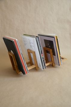 three books are stacked on top of each other in the shape of an easel