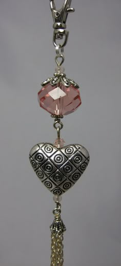 a heart shaped pendant hanging from a chain