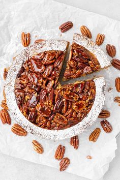 a pecan pie with one slice cut out and sitting on top of the other