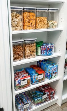 an organized pantry with cereal, snacks and other items in plastic containers on the shelves