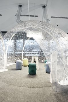 the inside of an inflatable bubble tent with various colored balls and stools