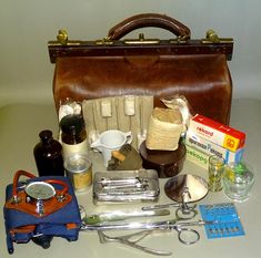 You are viewing a Vintage Old First Aid Doctor's Bag with Medical Equipment Inside. Vintage Doctor's Bag made of Synthetic Leather. Inside Bag have vintage medical doctor's pieces: -  two different size medical bottles in color glasses and one piece white medical jug; -  small cup glass, small blood cupping glass, and Bakelite box; -  medical package and four pieces a big size needles in original package; -  set of metal medical and doctor's instruments and tools in used condition: metal tongue Vintage Medical Equipment, Tongue Depressor, Color Glasses, Medical Bag, Medical Kit, Vintage Medical, Doctor Bag, Inside Bag, Carton Box