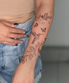 a woman's arm with a humming tattoo on the left side of her body