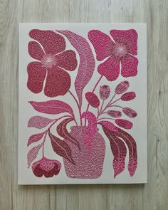 a pink vase with flowers is on a white background and sits on a wooden surface