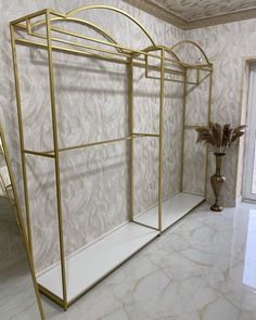 a gold and white bathroom with marble flooring