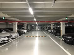 an empty parking garage with several cars parked in the space next to eachother