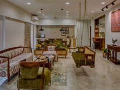 a living room filled with furniture and lots of windows