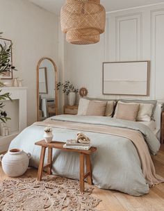 a bedroom with a bed, mirror and plant on the wall in front of it