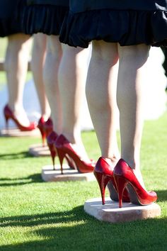 the legs and ankles of women in high heeled shoes on display at an event