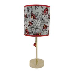 a red and white lamp with iron man fabric shade on the bottom, sitting on a gold base