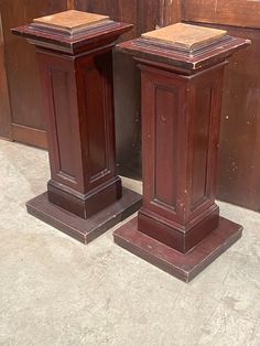 two wooden pedestals sitting next to each other