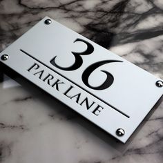 a close up of a number plate on a marble surface with the words park lane