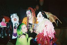 group of people dressed up in costumes posing for the camera