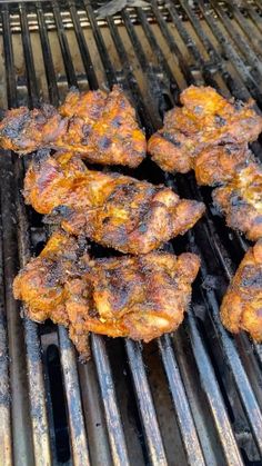 several pieces of chicken cooking on a grill