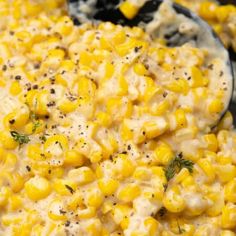 a bowl filled with corn on top of a table