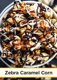 a bowl filled with popcorn covered in chocolate and drizzled with white icing