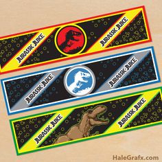 three dinosaur themed name tags on a wooden surface with an image of a t - rex