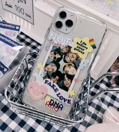 a cell phone case sitting on top of a table next to some stickers and other items