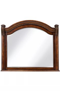 a wooden frame mirror on top of a white wall with an ornate border around it